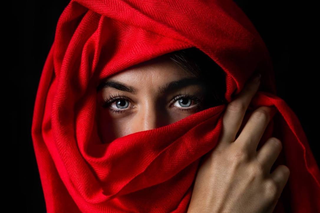 photo of person covered by red headscarf